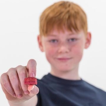 Photo of a child holding a vitamin stock to represent the sugar free kids vitamins. 